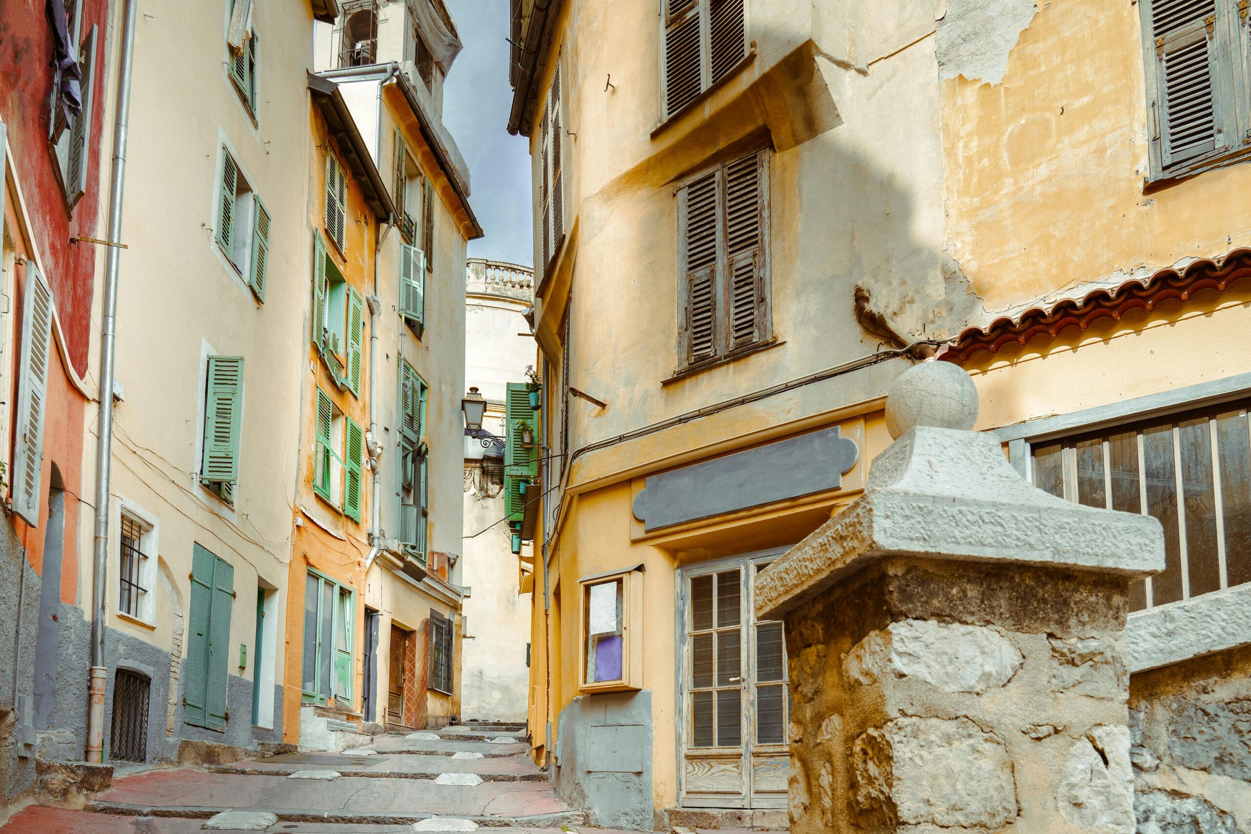 Explore the charming narrow streets and historic architecture of Nice, France's old town.